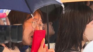 An einem verregneten Tag hat sich eine weinende Menschenmenge im Everland-Vergnügungspark in der Nähe von Seoul in Südkorea versammelt.