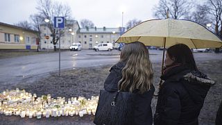 People bring candles and flowers at the Viertola school in Vantaa, Finland, Tuesday April 2, 2024, after a shooting incident. 