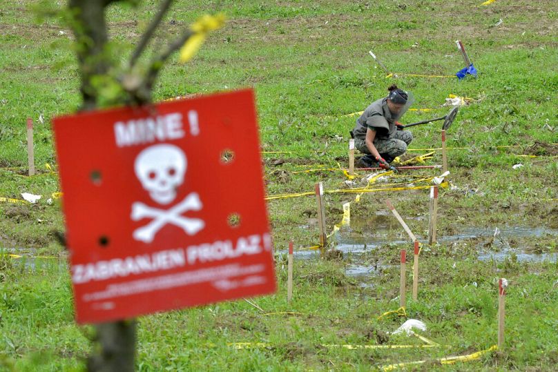 A Bosnian soldier searches for mines in fields near the banks of the river Bosnia which flooded near the town of Visoko, May 2014