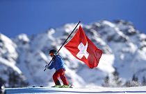 A young Swiss supporter hold a Swiss banner prior to the start of alpine ski, women's World Cup giant slalom, in Lenzerheide, Switzerland, Saturday, Jan. 27, 2018.