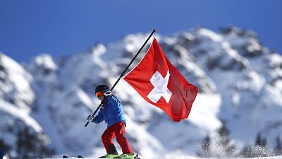 A young Swiss supporter hold a Swiss banner prior to the start of alpine ski, women's World Cup giant slalom, in Lenzerheide, Switzerland, Saturday, Jan. 27, 2018.