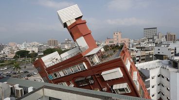 A partially collapsed building stands at a titled angle a day after a powerful earthquake struck in Hualien City, eastern Taiwan, Thursday, April 4, 2024. 