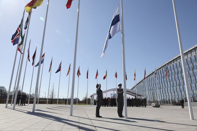 Military personnel raise the flag of Finland during a flag raising ceremony on the sidelines of a NATO foreign ministers meeting at NATO headquarters in Brussels, April 2023