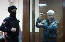 The co-chair of the Nobel Peace Prize winning Memorial Human Rights Centre Oleg Orlov gestures standing in a glass cage after he was taken into custody in the courtroom,Feb 23