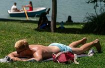 A young man sunbathes in Madrid, Spain, during scorching temperatures in August 2021.