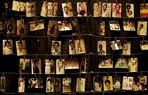 In this Friday, April 5, 2019 file photo, family photographs of some of those who died hang on display in an exhibition at the Kigali Genocide Memorial centre in Kigali