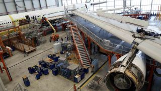 Employees work on an aircraft at the Elbe Aircraft Factory during a visit of German chancellor Olaf Scholz in Dresden, Germany, Thursday, Feb. 29, 2024. 