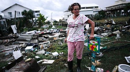Žena stoji pokraj ruševina kuće svoje majke u Horseshoe Beachu na Floridi, koju je krajem kolovoza 2023. pogodio uragan Idalia.