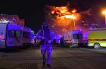 A Russian National Guard servicemen deployed near a massive blaze seen over the Crocus City Hall on the western edge of Moscow.