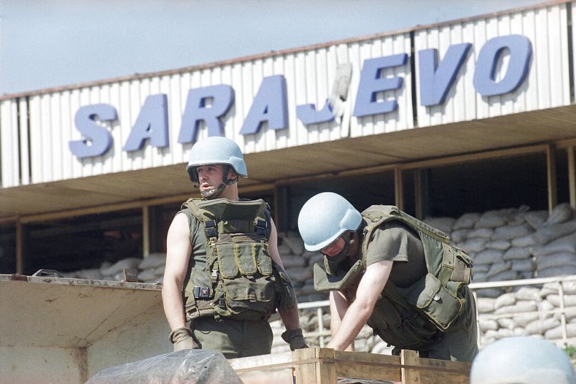Dois capacetes azuis franceses descarregam um carregamento de ajuda humanitária no aeroporto de Sarajevo.