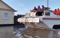 Εmergency workers aboard an amphibious vehicle look to evacuate local residents after a part of a dam burst causing flooding, in Orsk, Russia