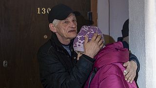 Husband comforts Liubov, 67, while they are hiding on a first floor of a residential house, during the air alarm after Russian attack in Kharkiv
