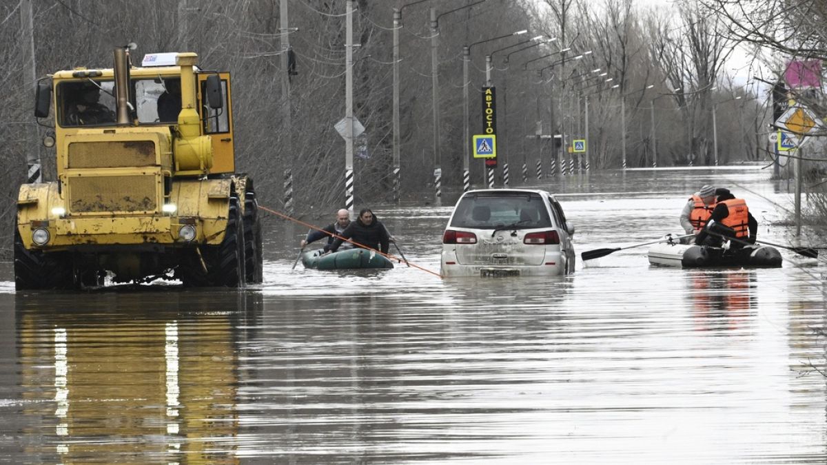 People use rubber boats in a flooded street after part of a dam burst, in Orsk, Russia.