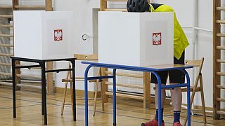 A man casts his ballot during local elections in Warsaw, Poland