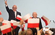 Conservative Law and Justice party leader Jaroslaw Kaczynski, right, joins supporters during Poland's local and regional elections in Warsaw, Poland, Sunday April 7, 2024.