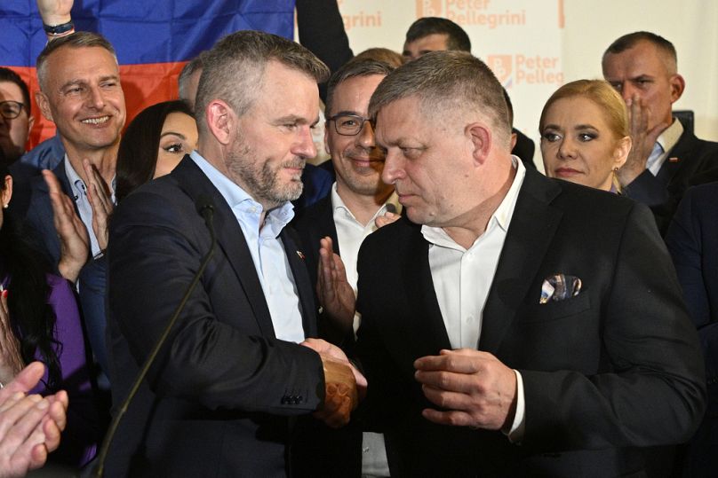Slovak President Peter Pellegrini, left, shakes hands with Prime Minister Robert Fico