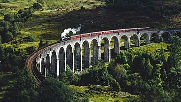 The luxury Royal Scotsman train travels across the iconic Glenfinnan Viaduct