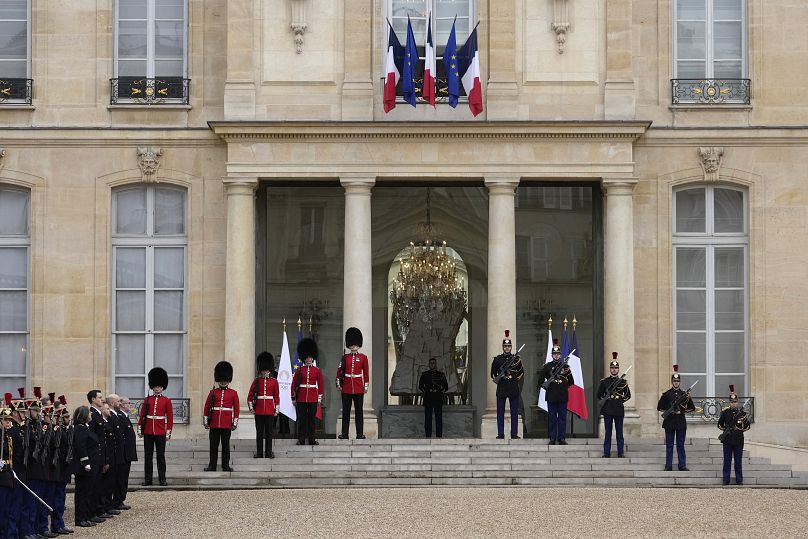 British soldiers and Republican Guards stand guard at the Elysee Palace