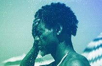 A man cools off in a shower at Ipanema beach, Rio de Janeiro, September 2023