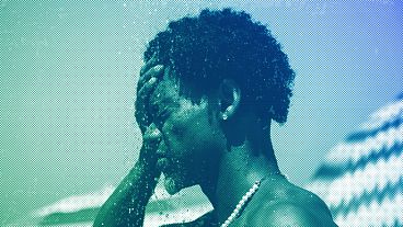 A man cools off in a shower at Ipanema beach, Rio de Janeiro, September 2023