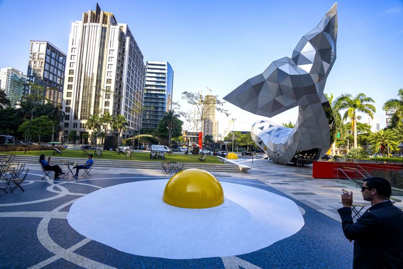 An art installation titled "Art Eggcident," by Dutch artist Henk Hofstra, featuring a sculpture of a giant, fried egg, in Sao Paulo, September 2023