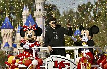 Kansas City Chiefs quarterback Patrick Mahomes, center, greets fans on Main Street, U.S.A, during a cavalcade through Disneyland in Anaheim, Calif., Monday, Feb. 12, 2024. 