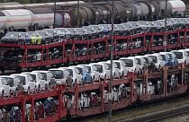 German cars created by Volkswagen and BMW are parked on a freight train in Munich, Germany. Oct. 14, 2021.