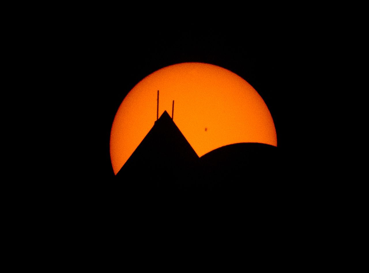 The Moon is seen passing in front of the sun with the top of the Washington Monument in silhouette during a solar eclipse in Washington.