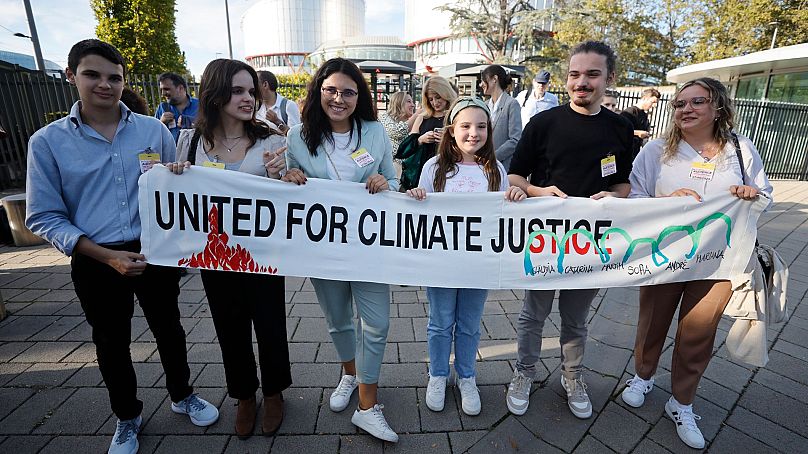 Portuguese young people pose with a banner outside the European Court of Human Rights on 27 September 2023 in Strasbourg, eastern France.