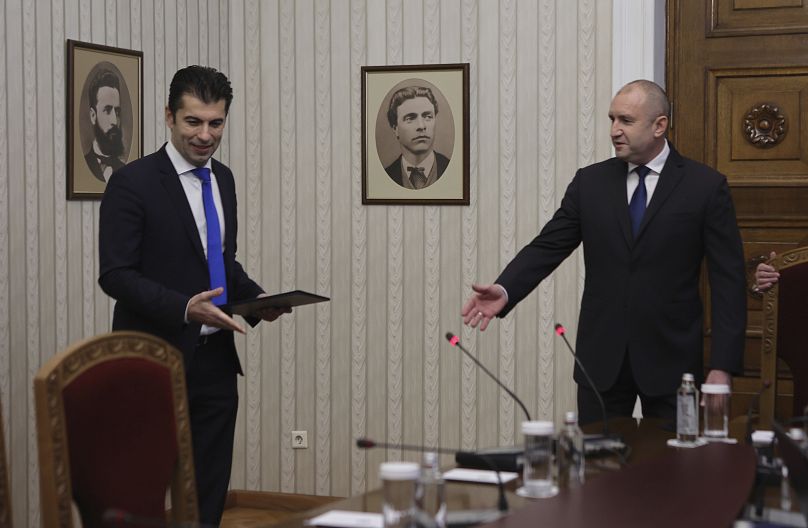 Kiril Petkov, left, co-leader of the We Continue the Change party, receives a mandate to form a new government from Bulgarian President Rumen Radev,