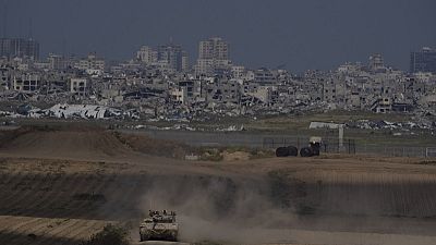 Israeli soldiers move on the top of a tank near the Israeli-Gaza border, as seen from southern Israel, Tuesday, April 9, 2024