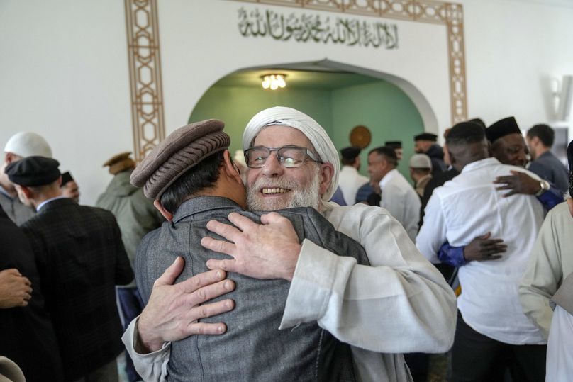 Muslims congratulate each other on Eid al-Fitr by hugging each other after the prayer in Berlin, Germany, Wednesday, April, 10, 2024.