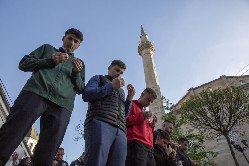 Muslims perform an Eid al-Fitr prayer outside Sultan Mehmet Fatih mosque in capital Pristina, Kosovo on Wednesday, April, 10, 2024.