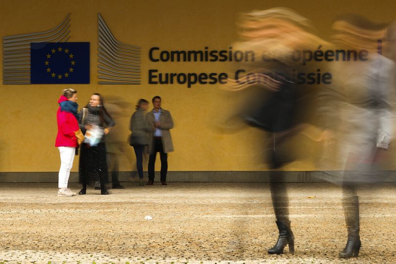 People walk past European Commission headquarters in Brussels, October 2018