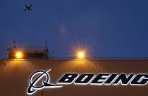 A plane flies over a sign on Boeing's 737 delivery centre at Boeing Field in Seattle, Oct. 19, 2015.