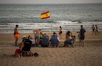 Bathers enjoy the beach in Barbate in southern Spain's Cadiz province.