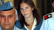 In this Sept. 26, 2008 Amanda Knox, center, is escorted by Italian penitentiary police officers to Perugia's court.