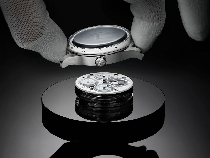 The complex mechanics are contained in a platinum case with a domed sapphire watch glass.