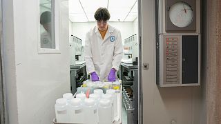 Jackson Quinn brings PFAS water samples into a temperature controlled room, 10 April 2024, at a US Environmental Protection Agency lab in Cincinnati.