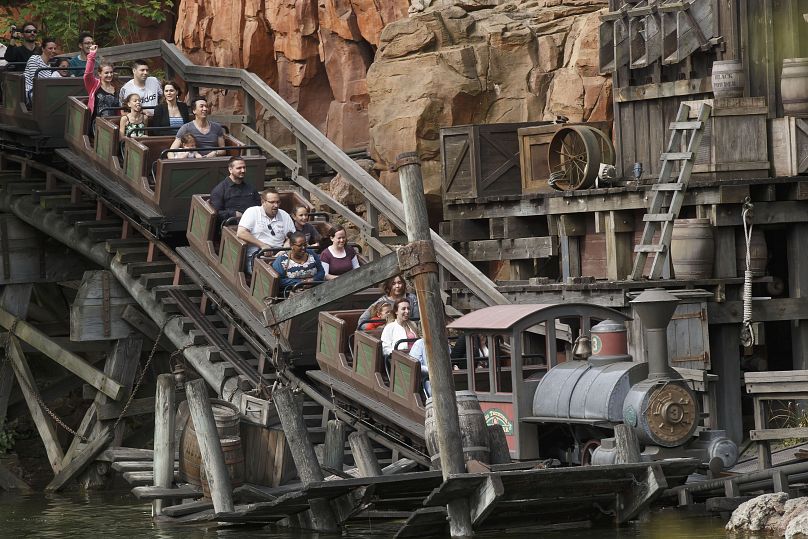 Visitors take a ride with the Big Thunder Mountain at Disneyland Paris, in Chessy, France, east of the French capital, Tuesday, May 12, 2015.