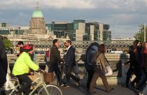 Pedestrians and cyclists pass each other at evening rush hour on O'Connell Bridge in central Dublin