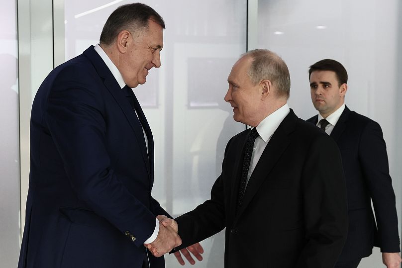 Russian President Vladimir Putin, right, gestures while speaking to Bosnian Serb political leader Milorad Dodik