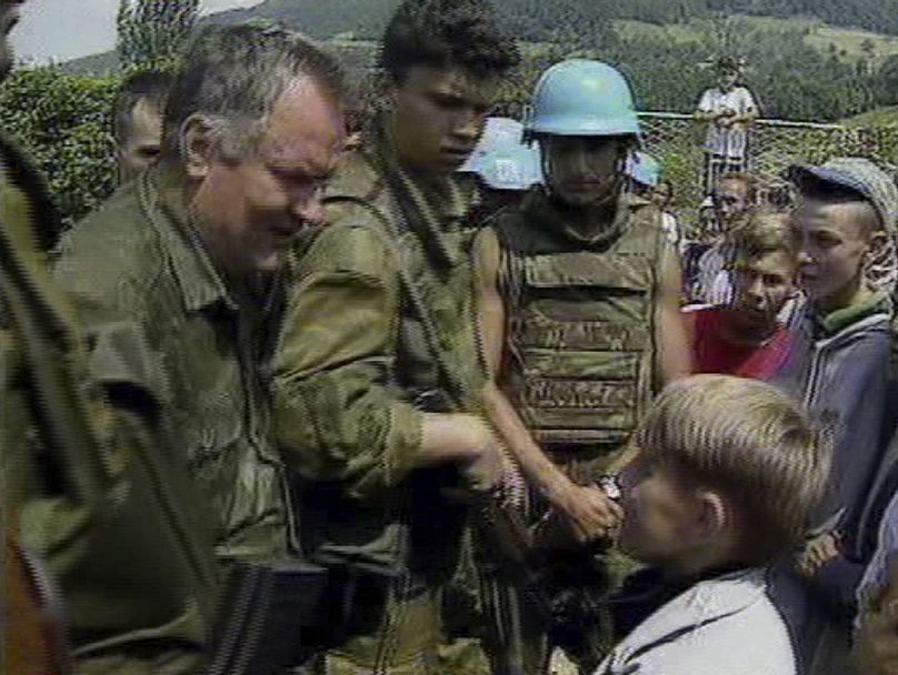 In this file image of July 12, 1995 taken from television Bosnian Serb General Ratko Mladic speaks to a young Muslim boy