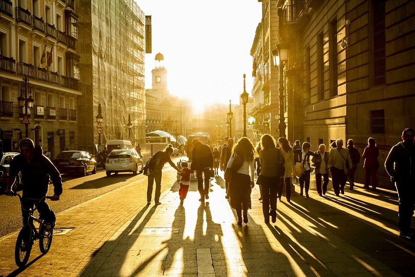 Super accessible: People walk in Madrid at golden hour