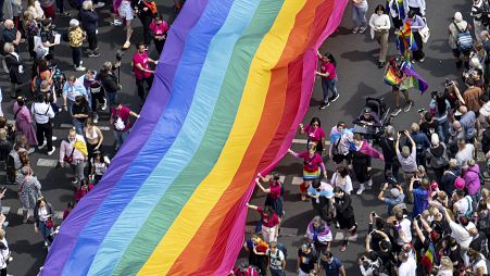 People hold a rainbow flag as they attend the 45th Berlin Pride Parade for Christopher Street Day (CSD) in Berlin, Germany.