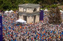 FILE - People holding European Union and Moldovan flags fill the Great National Assembly Square in Chisinau, Moldova, Sunday, May 21, 2023. 