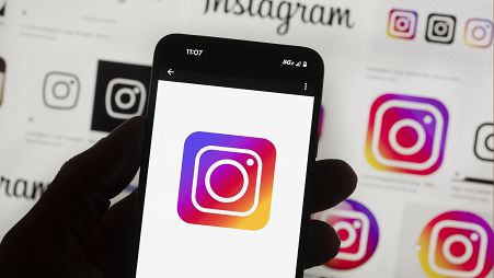The Instagram logo is seen on a phone.
