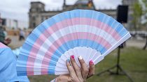 A blue, pink and white fan. 