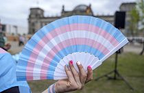 A blue, pink and white fan. 