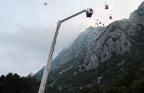 A rescue team work with passengers of a cable car transportation systems outside Antalya, southern Turkey, April, Friday 12, 2024. 